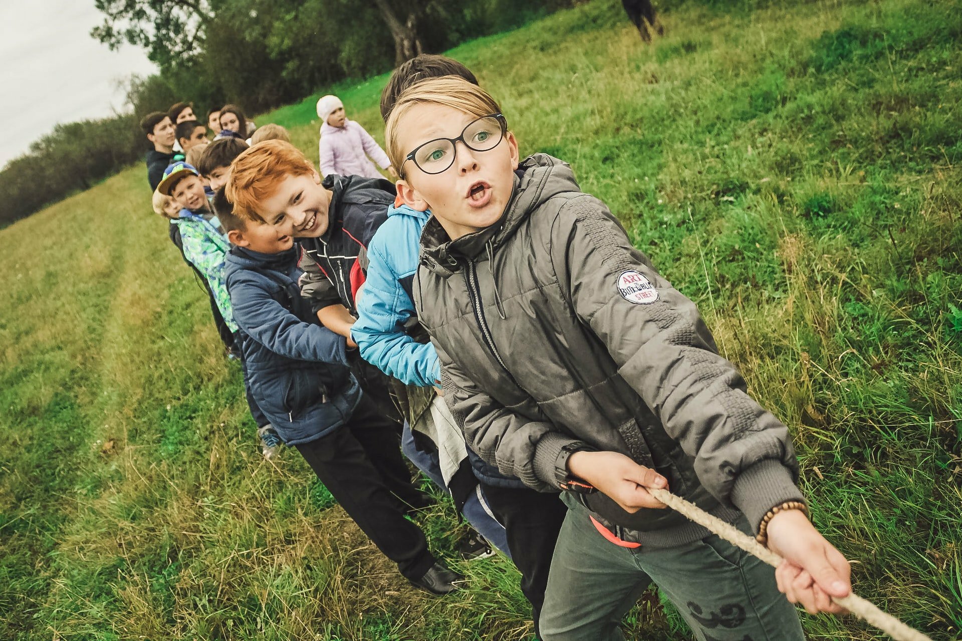 a group of people in a grassy field