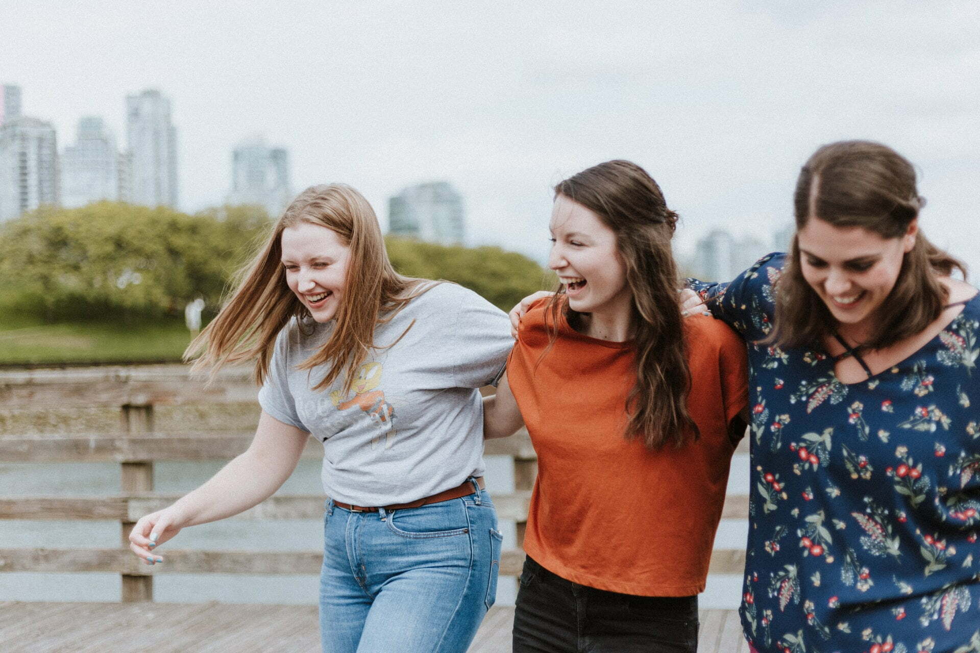 a group of women walking on a boardwalk