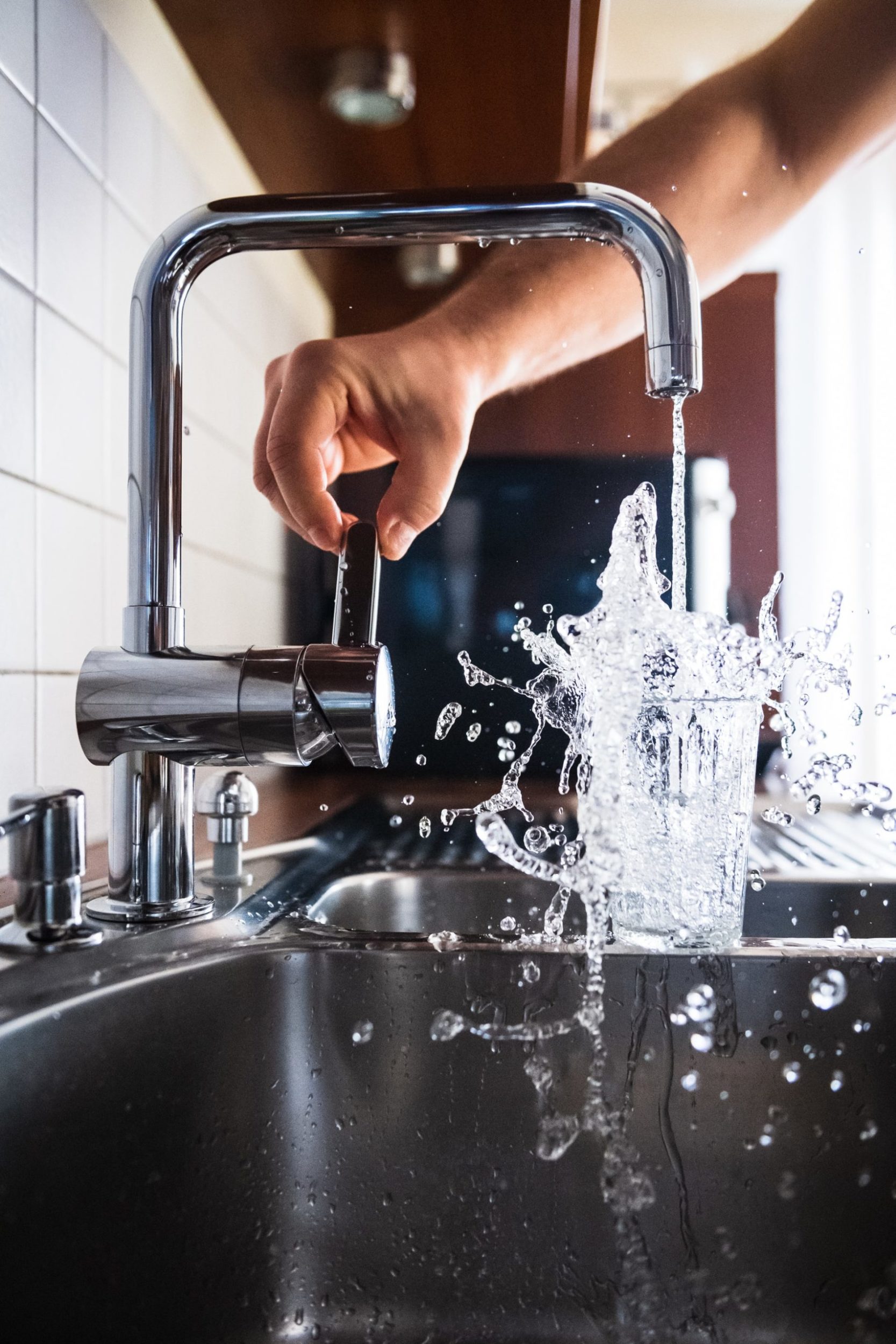 a person washing a sink