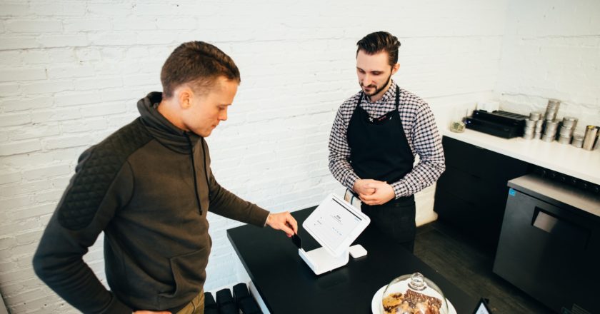 a man and a woman looking at a paper
