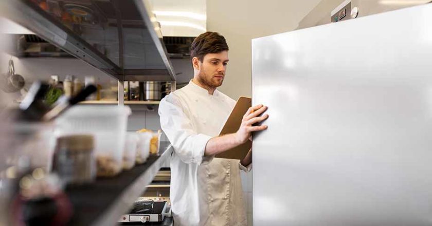 a person in a lab coat looking at a whiteboard