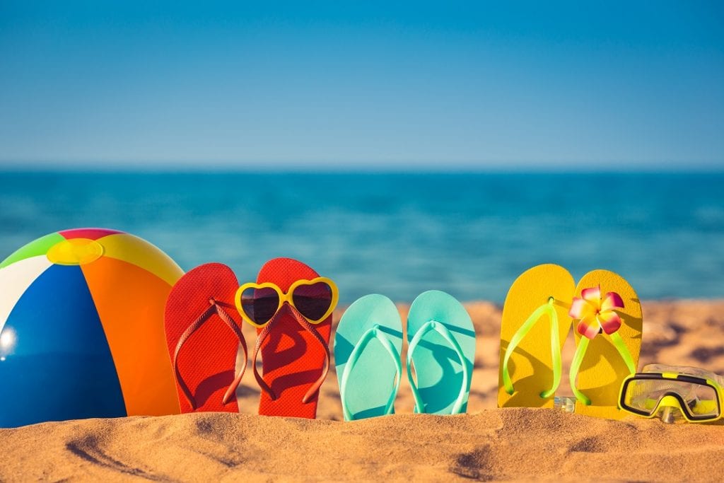a group of flip flops on a beach
