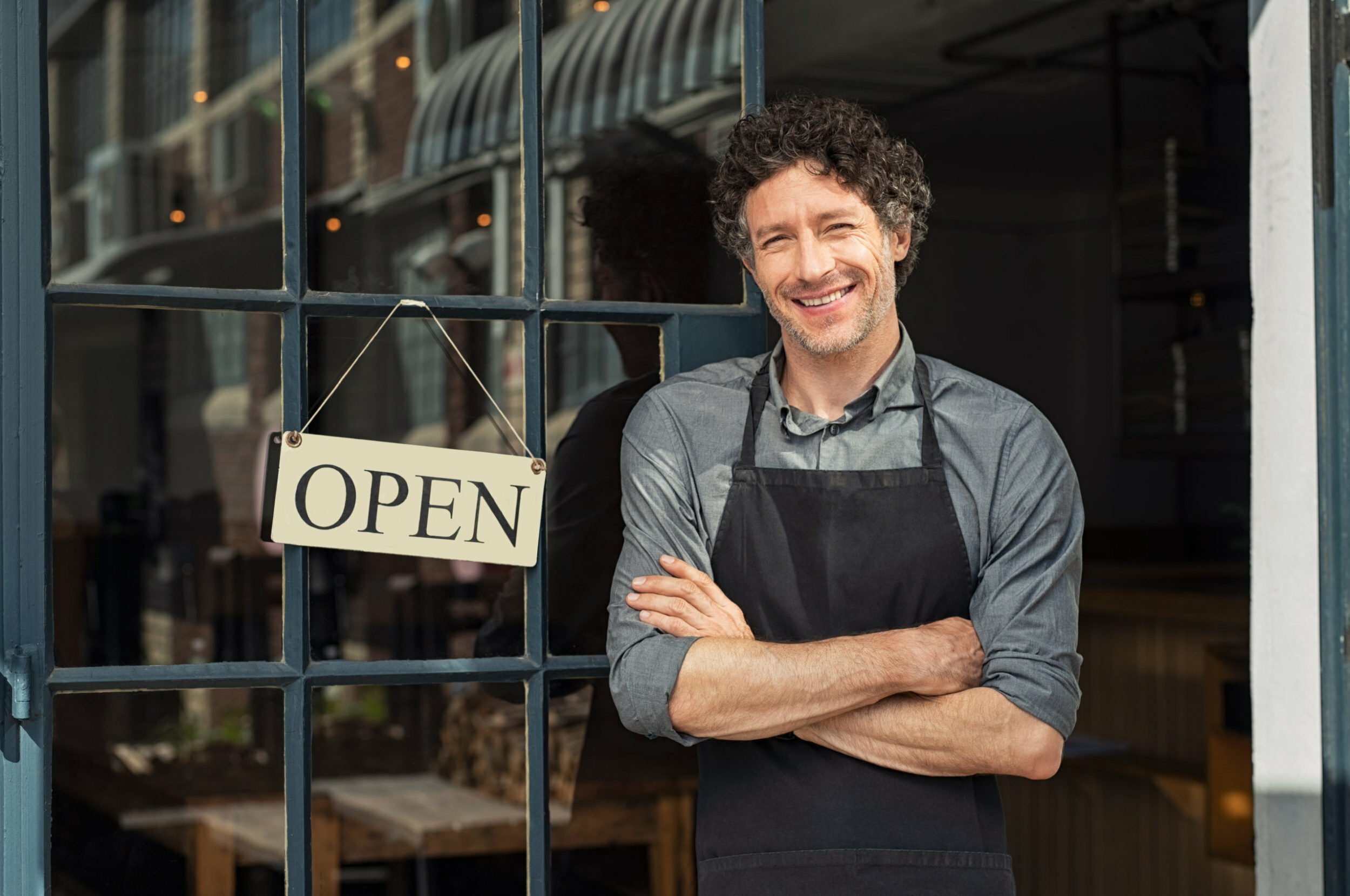 man standing outside his business
